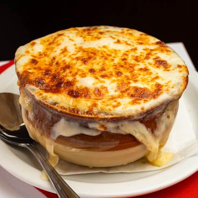 French onion soup topped with melted cheese in a ceramic crock