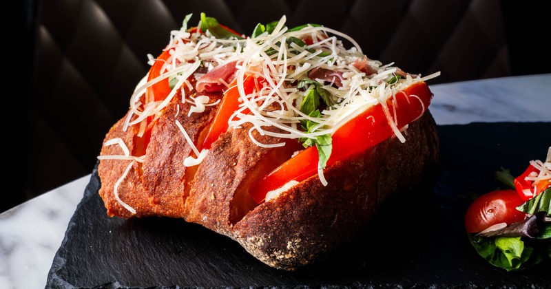 Ciabatta bread with mozzarella, tomato sauce, tomato, and basil
