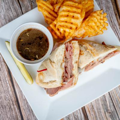 French dip sandwich served with waffle fries.