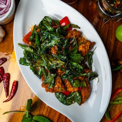 Deep fried catfish, topped with spicy sauce, and spinach.