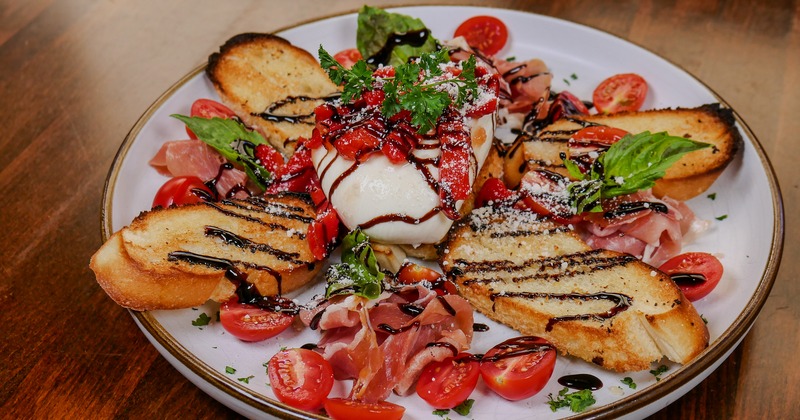Burrata with prosciutto and grilled bread dressed with balsamic vinegar