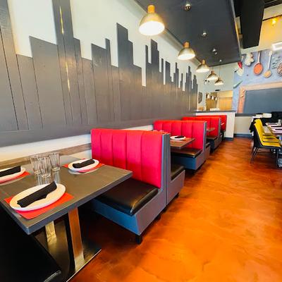 Interior with booth seating and tables set for guests.