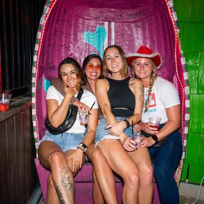 A group of customers sitting together and posing for a shot.