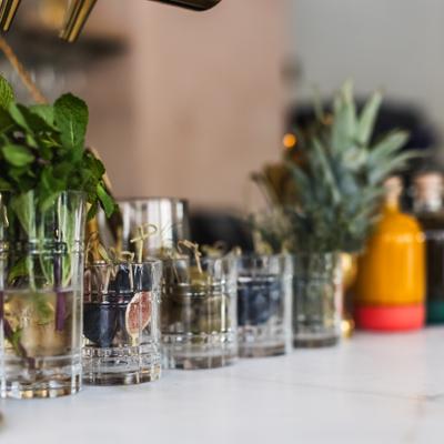 Various cocktail garnishes displayed in glasses on a bar counter.
