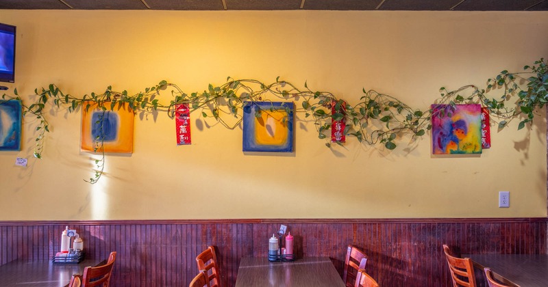 Diner area, tables and chairs by the decorated wall