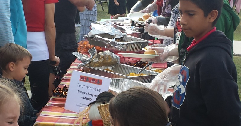 People gathered around a catering plate at an event