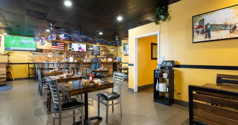 Interior, tables and chairs, bar in the back