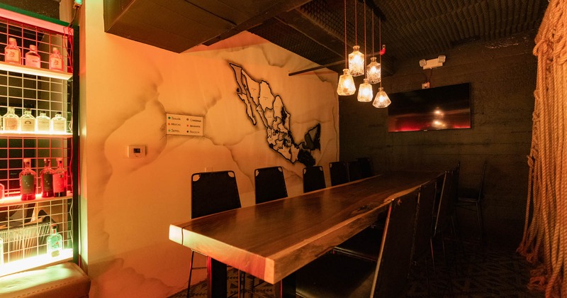 Interior, private table with seats, hanging lanterns, mural art and wall TV