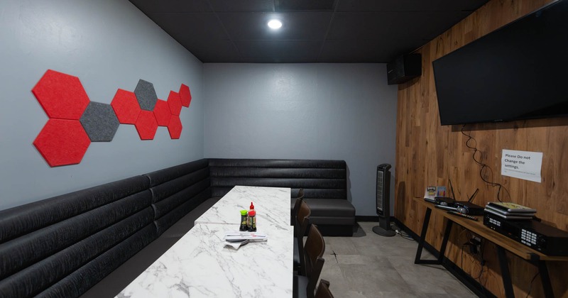 Interior space, seating booth and big TV on the wall