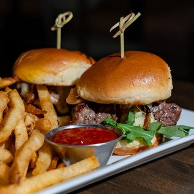 Filet Sliders served with a side of fries and a dipping sauce.