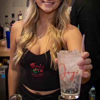 A person holding up a drink.