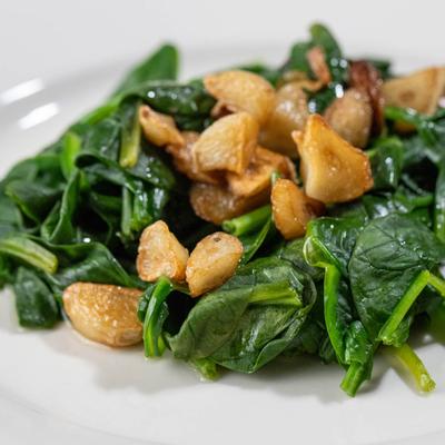 Steamed spinach with tossed home fries.