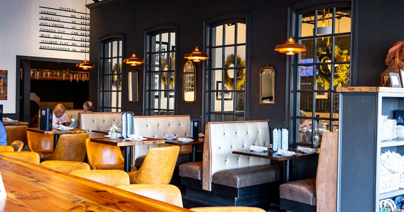 Nicely done interior dining area, dining booths set for guests