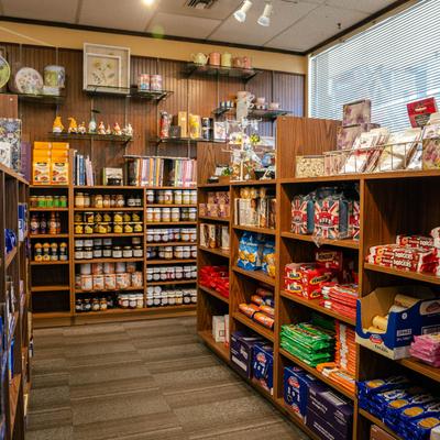 Shelves in the store stocked with biscuits and jam.