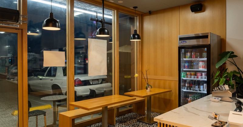 Interior, seating area with two tables near the order counter
