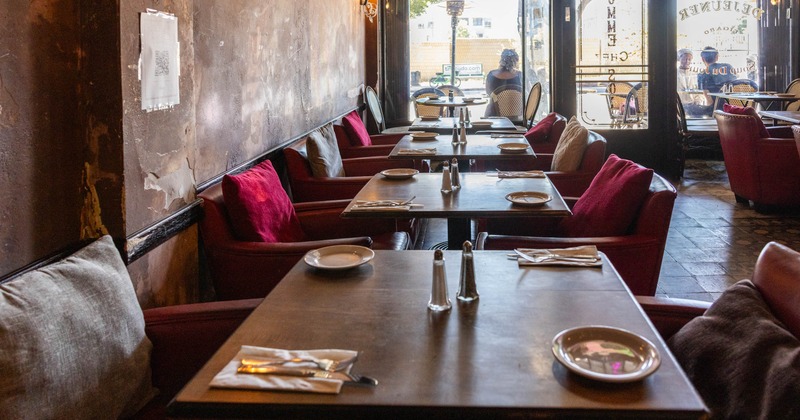 Interior, dining area, wooden top tables for two, leather arm chairs