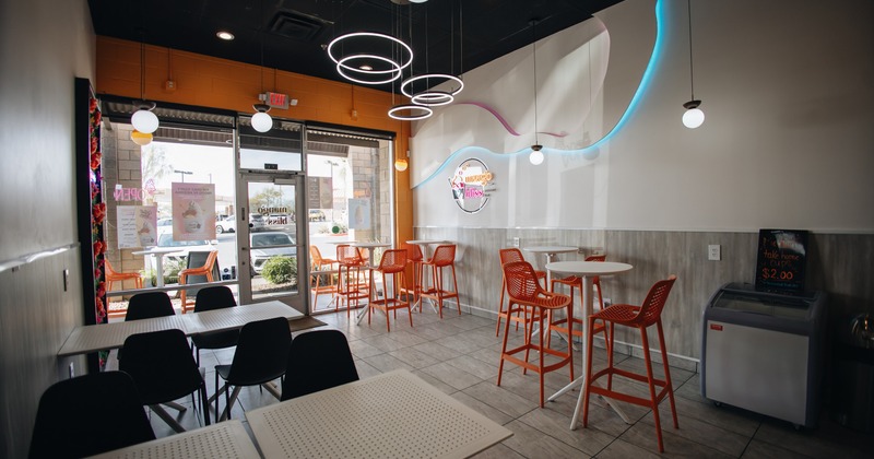 Interior with tables and chars, neon signs on the wall