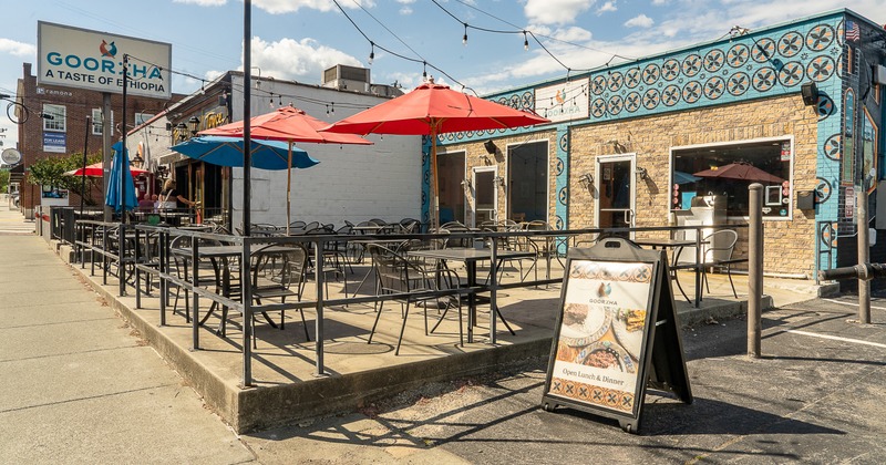 Exterior, side walk patio, chairs, tables, parasols