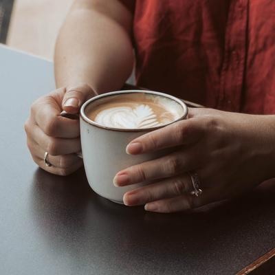 Hands holding a cup of coffee.