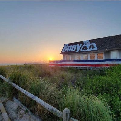 Beachside restaurant building with a signage on the roof.