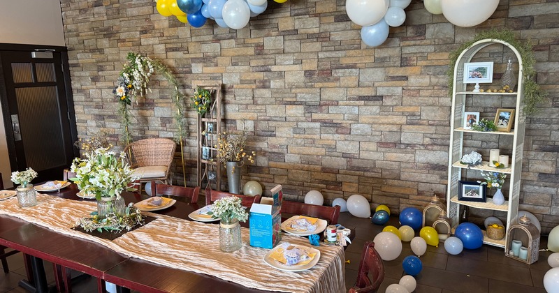Interior seating area decorated with balloons and ready for a private party