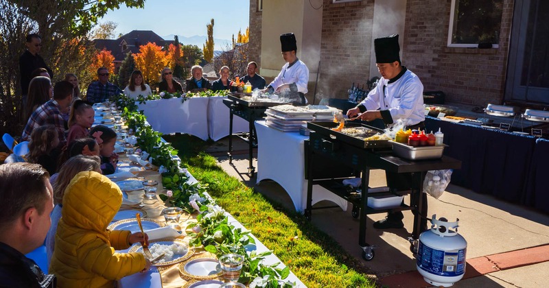 Chefs prepare food while the guests sit at their tables