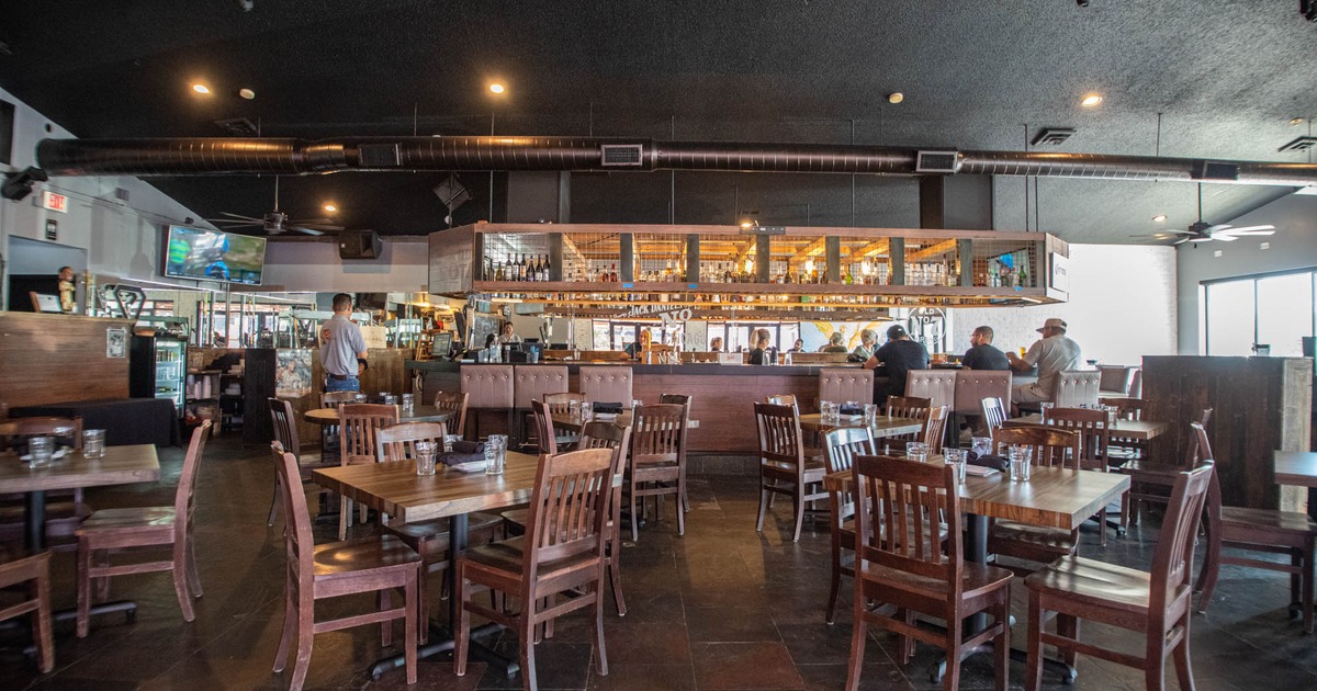 Interior, dining tables and seats, bar in the back