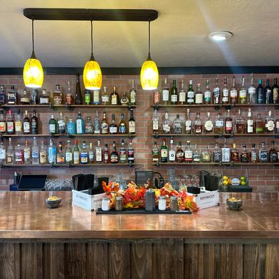 Bar area, various liquor bottles on the shelf.