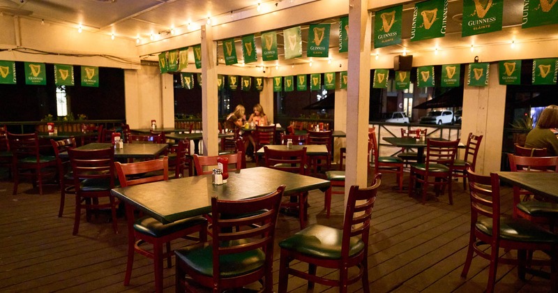 Dining area at night with lights on, tables and chairs waiting for the guests