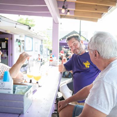 Exterior, patio, guests at the bar.