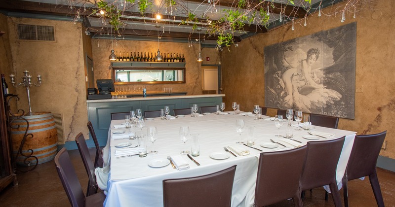 Private space area with a large dining table elegantly set for fourteen guests
