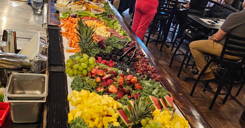 A large, elaborate grazing board, at a catered event
