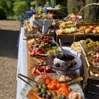 Prepared food, served on tables outdoors.