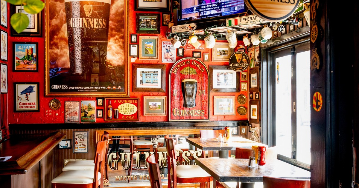 Interior, seating area with table and chairs, bar memorabilia on the walls