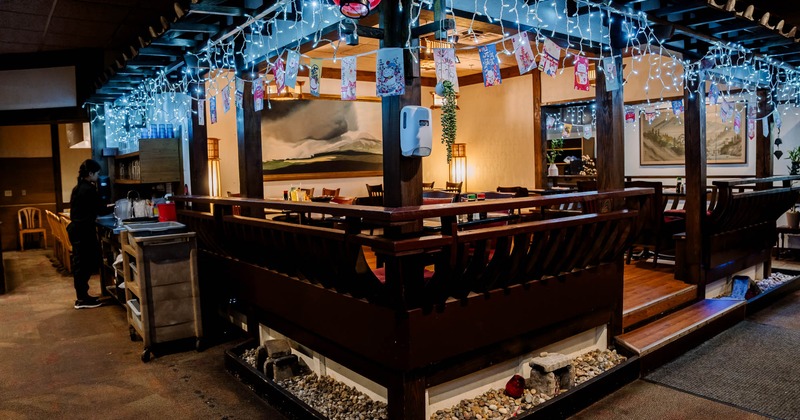 Interior, indoor pergola with dining tables and chairs, lantern decoration