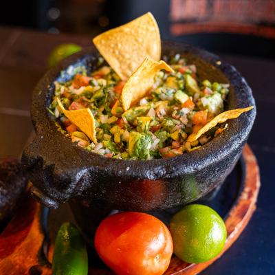 Chunk of avocado mixed with onions, tomatoes, cilantro and jalapeños peppers.