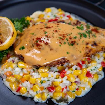 Blackened snapper topped with Cajun creme sauce, served with corn risotto.