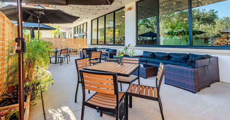 Patio area, with tables, chairs, and outdoor lounge sofas
