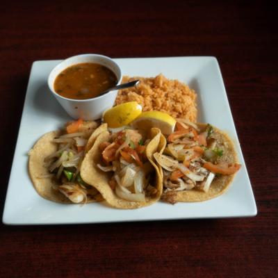 Plate of Chicken Tacos served with rice and sauce.
