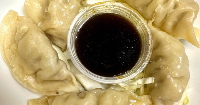 Steamed gyoza dumplings served with a soy sauce