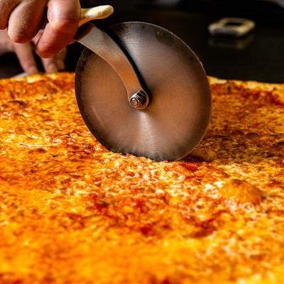 Cheese pizza cutting.