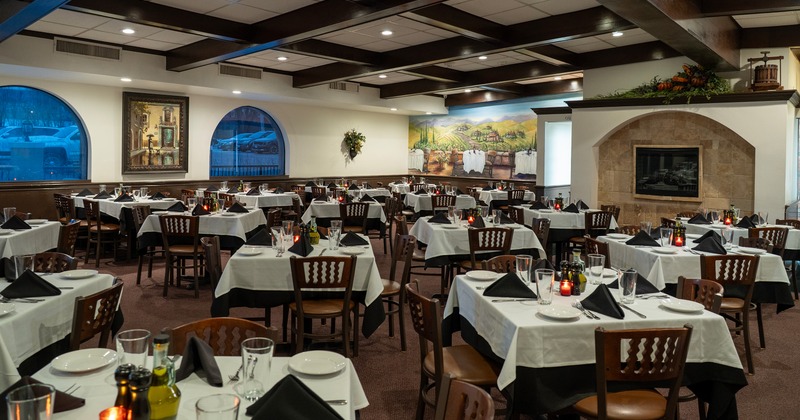 Spacious and cozy interior dining area with set tables, perfect for larger events