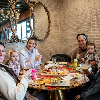 Several people seated at a table, enjoying family time and sharing a meal.