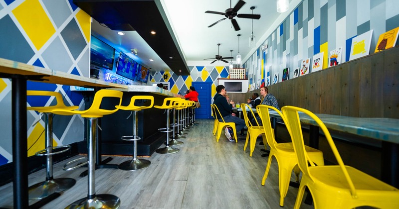 Interior, dining area, tables, yellow chairs and bar stools