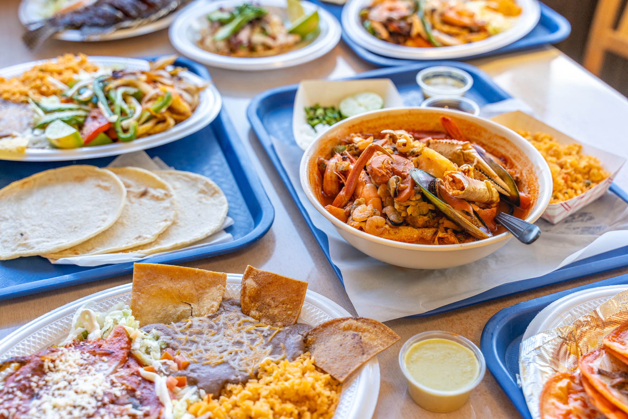 A fully served table with various meals