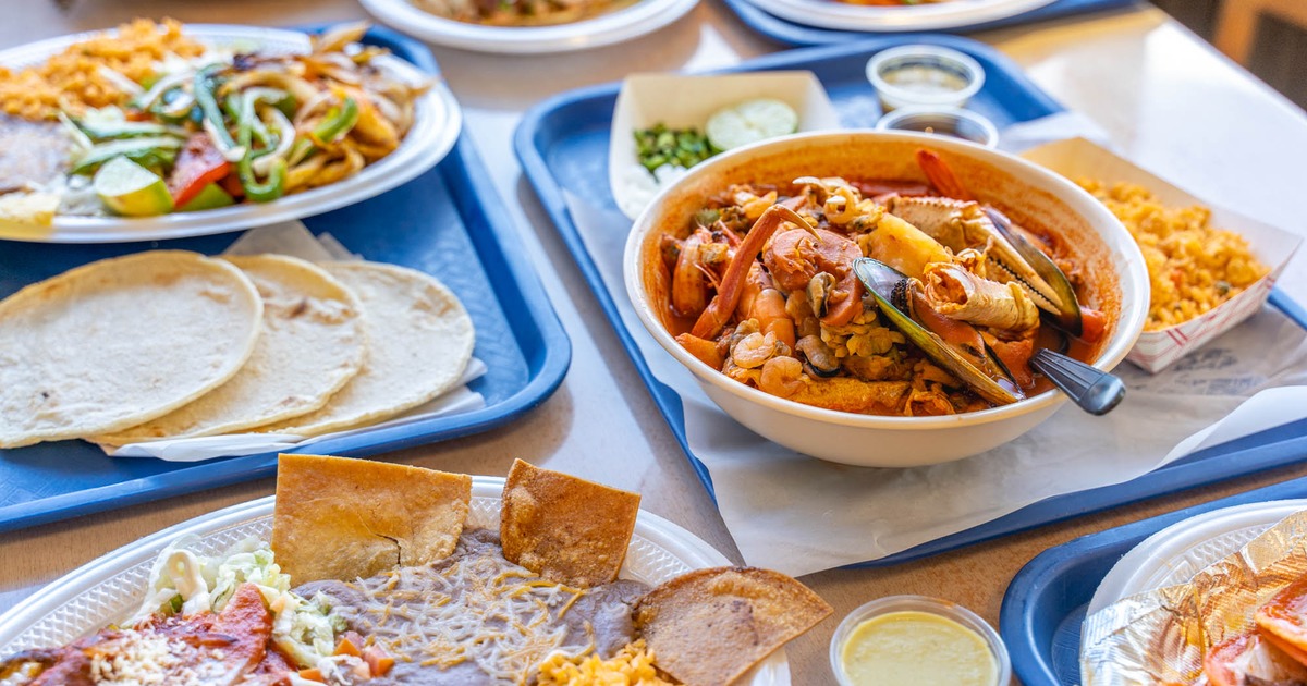 A fully served table with various meals