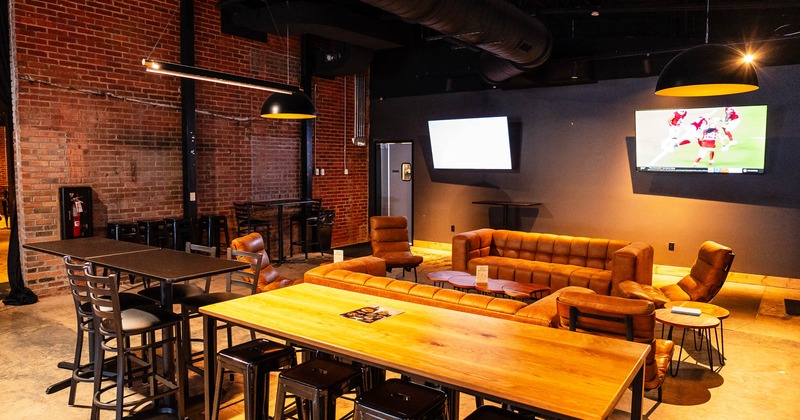 Interior, tables, chairs and sofas, tv screens on the wall