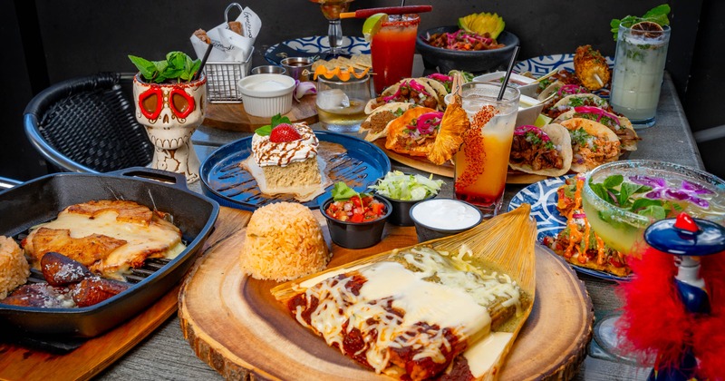 Colorful table spread of assorted dishes and cocktails