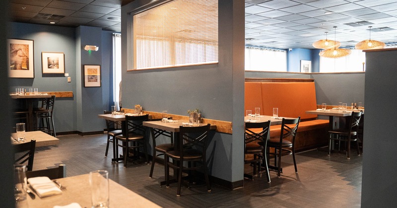 Interior, tables for two, bench seating in the background