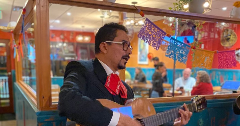 Mariachi singers playing guitar at Coyote Flaco